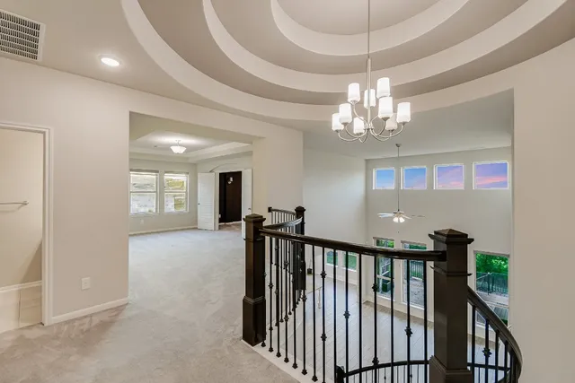 a view of a hallway with chandelier and chandelier