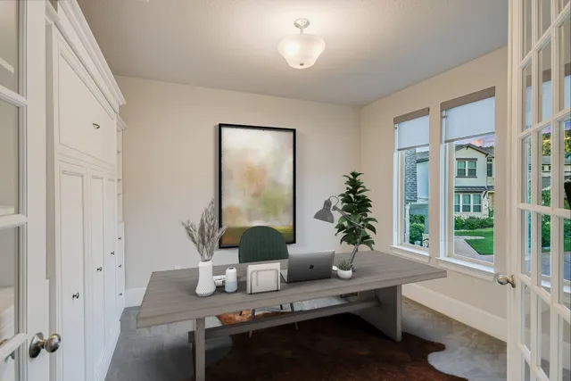 a living room with furniture and potted plants