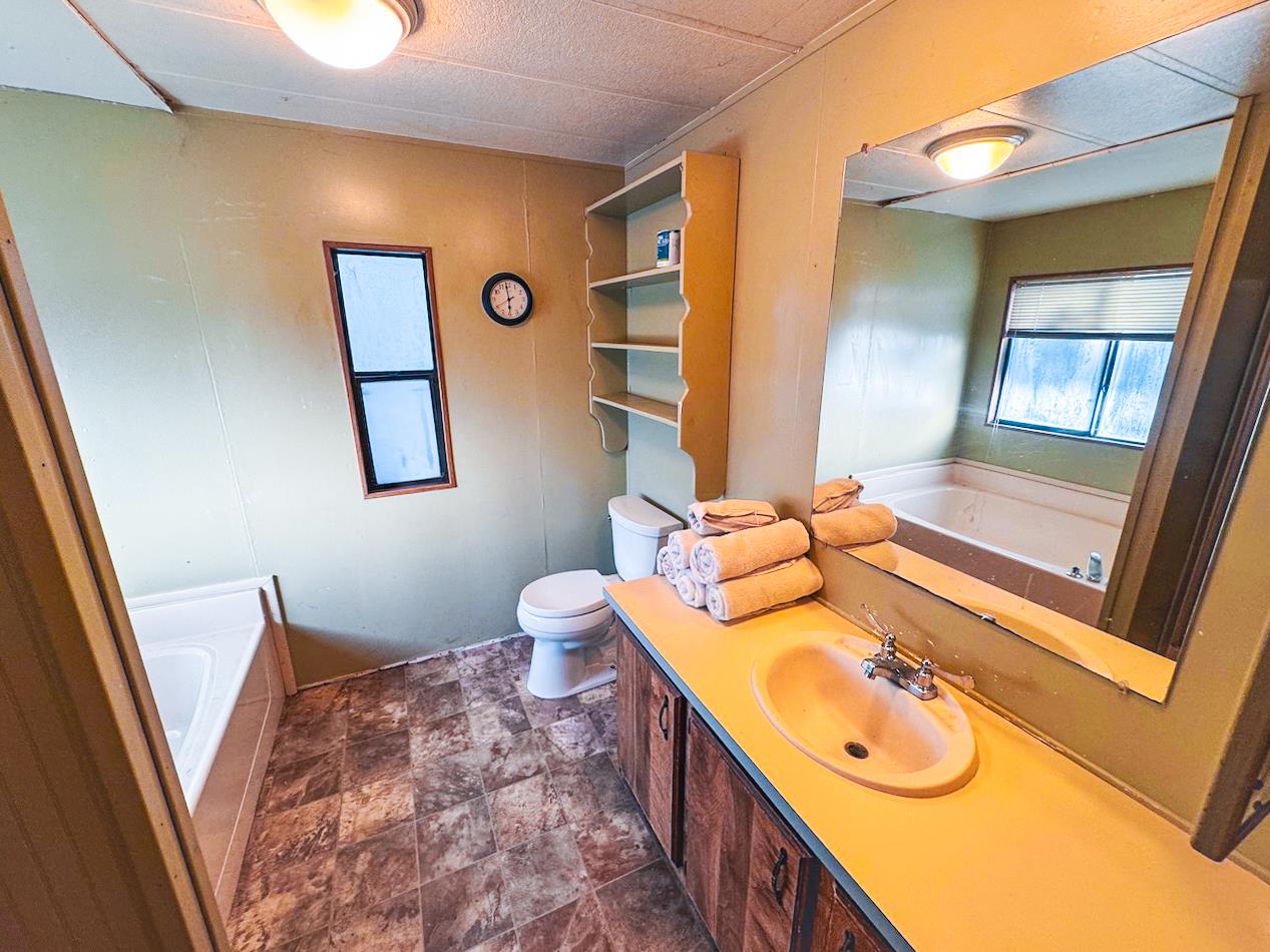 314 South Main Street, Unit 187 Angels Camp, CA 95222 - Photo 18 of 27 a bathroom with a sink mirror vanity and toilet
