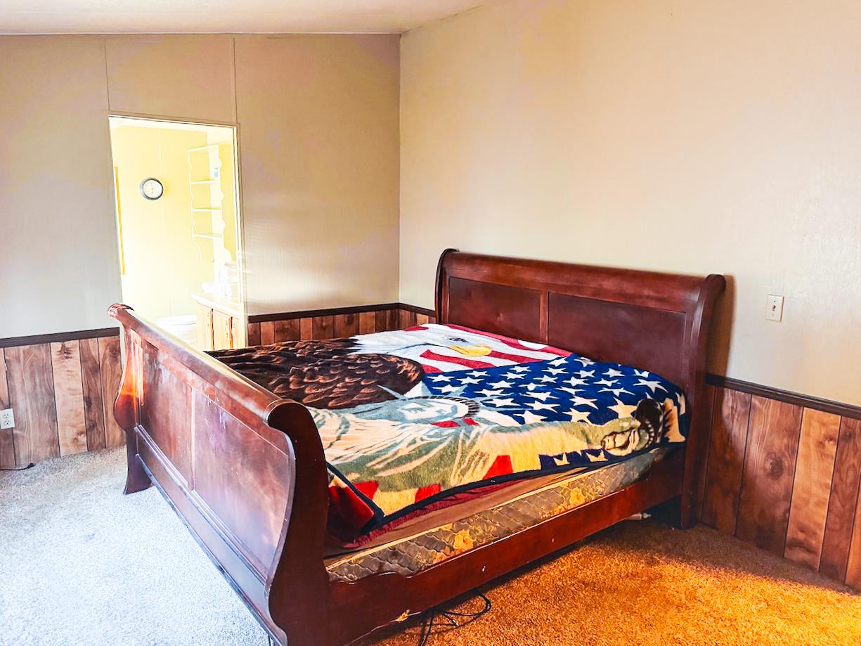 314 South Main Street, Unit 187 Angels Camp, CA 95222 - Photo 21 of 27 a bed sitting in a bedroom next to a window