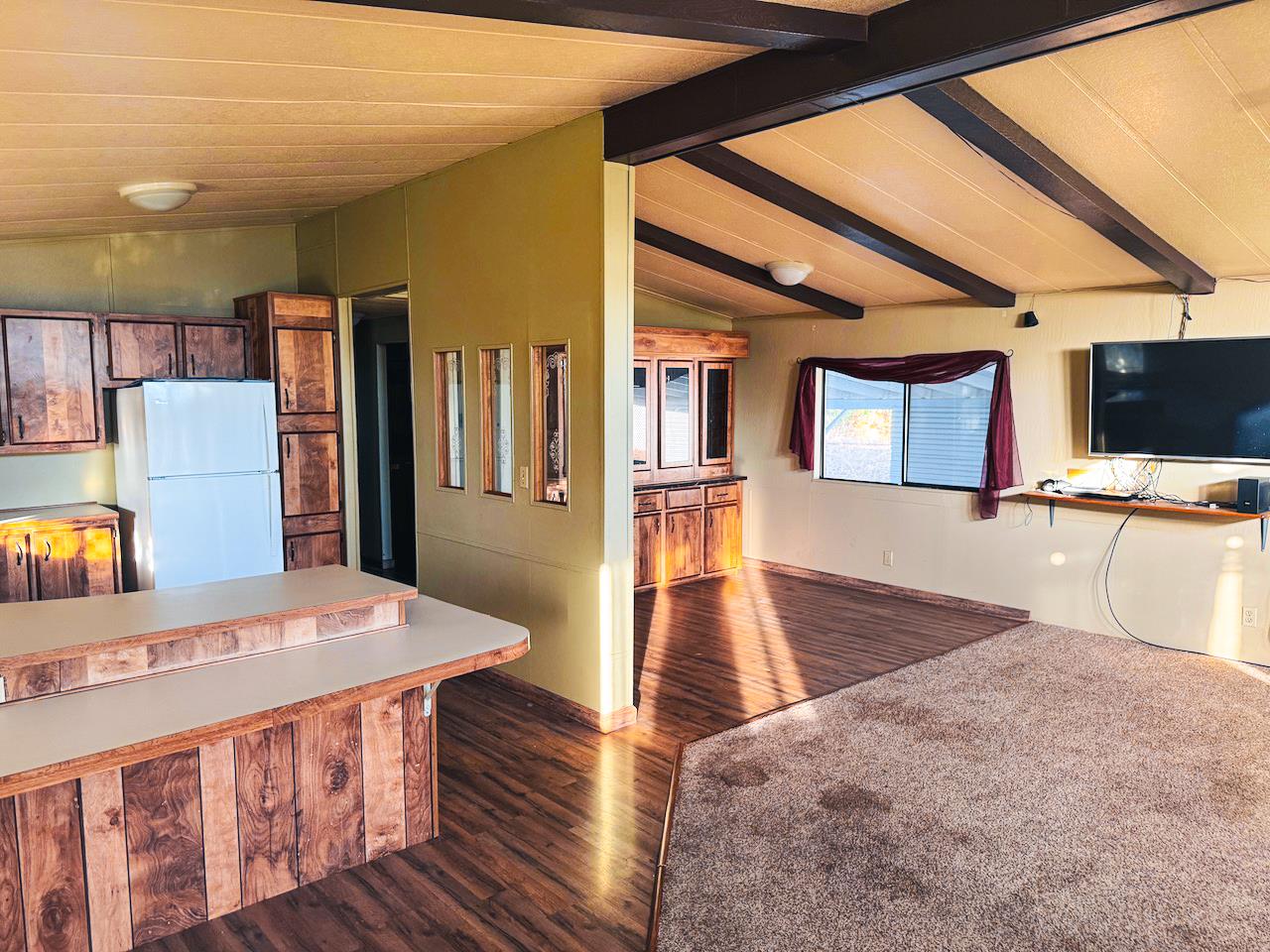 314 South Main Street, Unit 187 Angels Camp, CA 95222 - Photo 22 of 27 a living room with stainless steel appliances kitchen island granite countertop a table chairs and a refrigerator