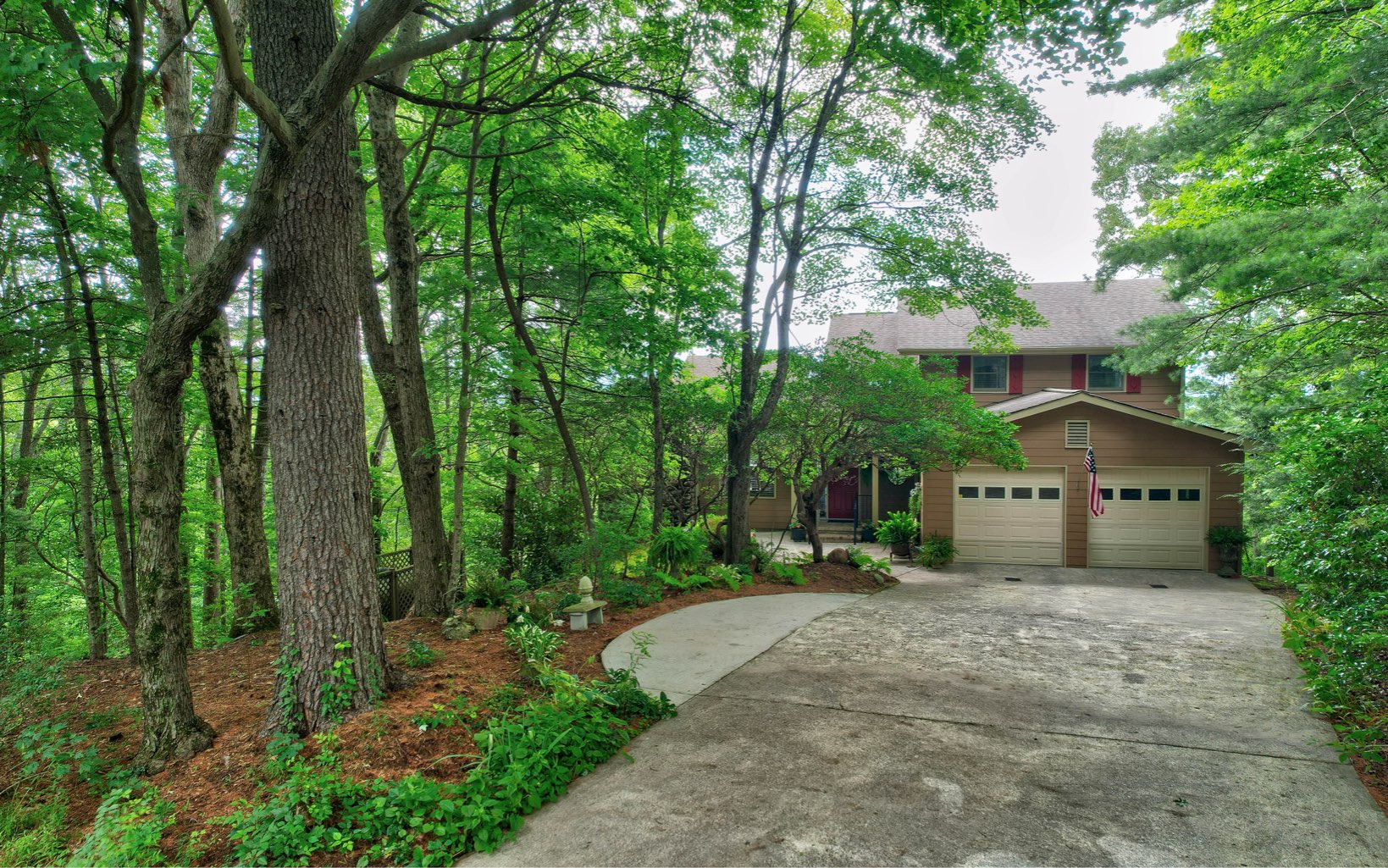 360 Apache Trail Chatsworth, GA 30705 - Photo 2 of 41 a big house with large trees and plants