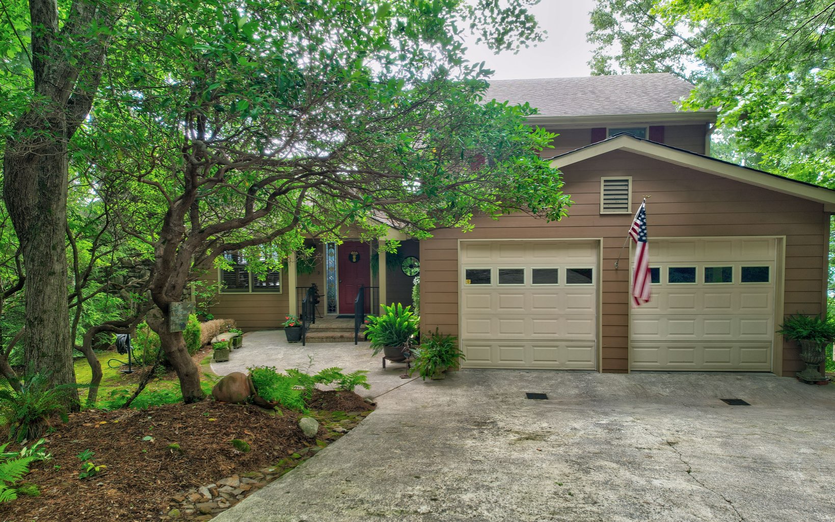360 Apache Trail Chatsworth, GA 30705 - Photo 3 of 41 a front view of a house with garden