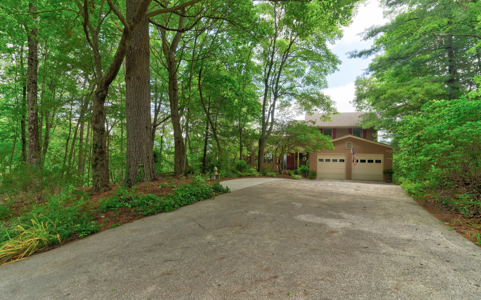 360 Apache Trail Chatsworth, GA 30705 - Photo 34 of 41 a front view of a house with a yard and trees all around