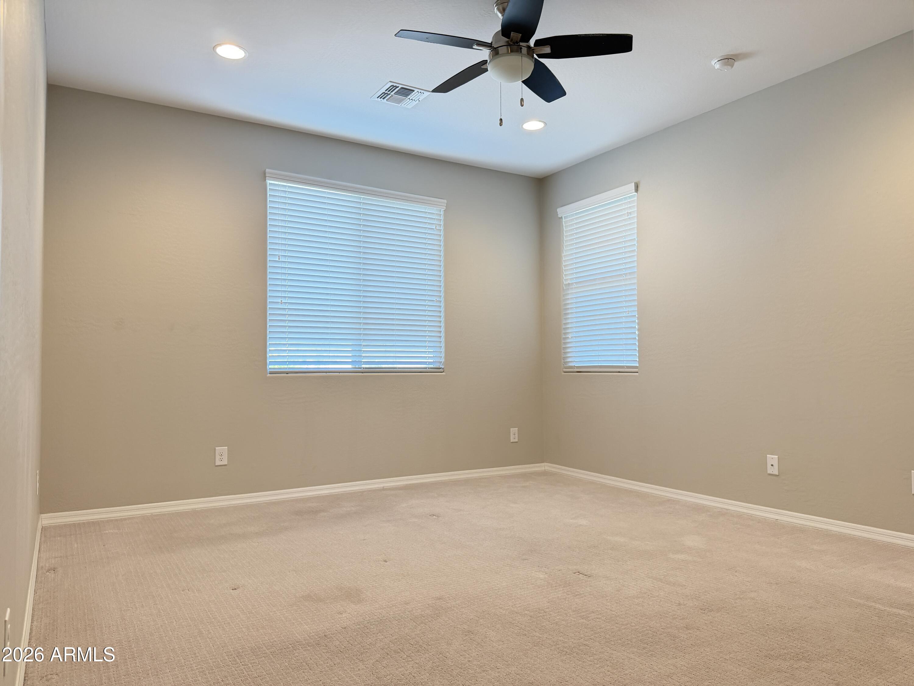 2314 East Harwell Road Phoenix, AZ 85042 - Photo 13 of 32 an empty room with a window and a fan