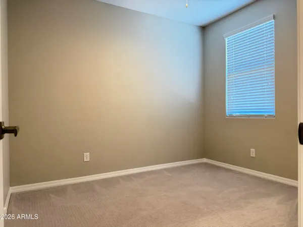 a view of a room with wooden floor and windows
