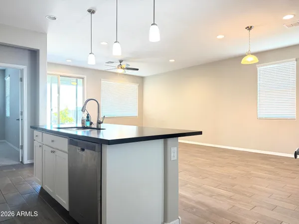 a kitchen with kitchen island a sink stainless steel appliances and a counter top space