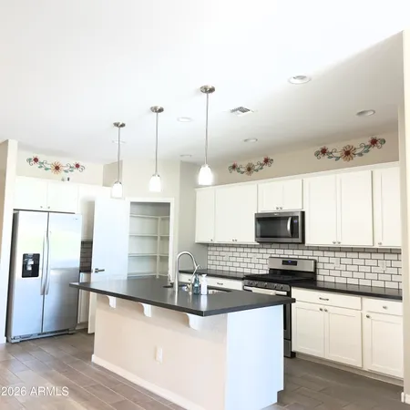 a kitchen with stainless steel appliances a stove sink and microwave