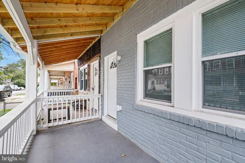 a view of a porch with wooden floor and fence
