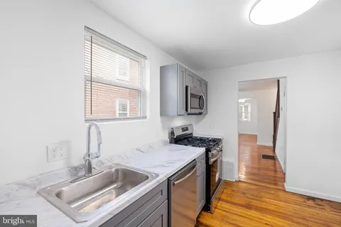a kitchen that has a sink and a stove in it