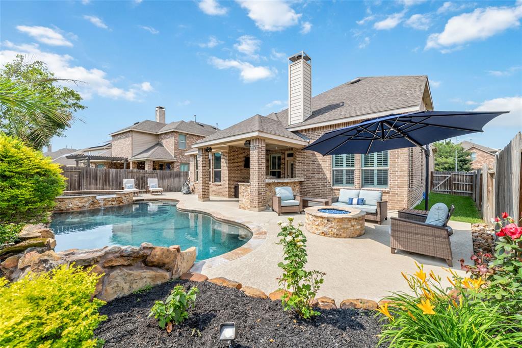 The perfect backyard oasis awaits!  Come relax around the fire pit, in the hot tub or swim in the pool while you listen to music on the integrated speakers, watch TV or just float the day away