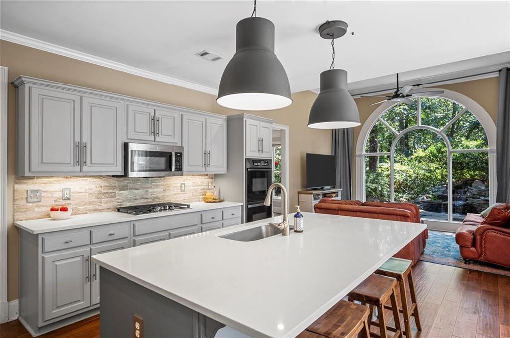 130 Belvedere Court Atlanta, GA 30350 - Photo 17 of 59 a kitchen with stainless steel appliances a stove a chimney a sink and a stove