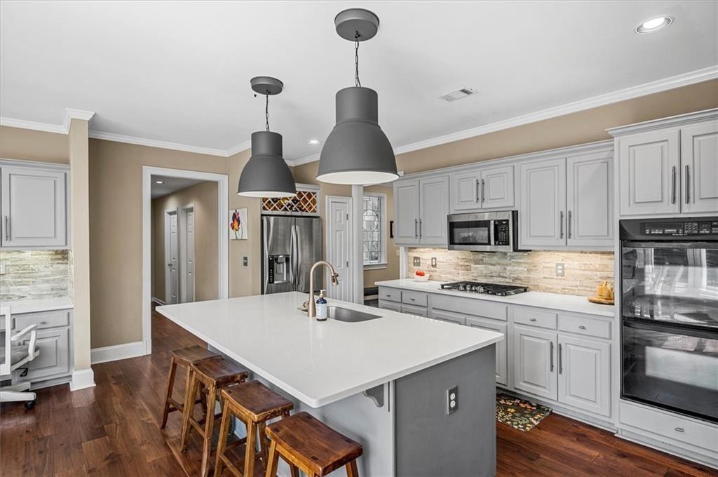 130 Belvedere Court Atlanta, GA 30350 - Photo 18 of 59 a kitchen with stainless steel appliances a sink a stove a refrigerator and cabinets