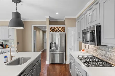 a kitchen with a table chairs and wooden floor