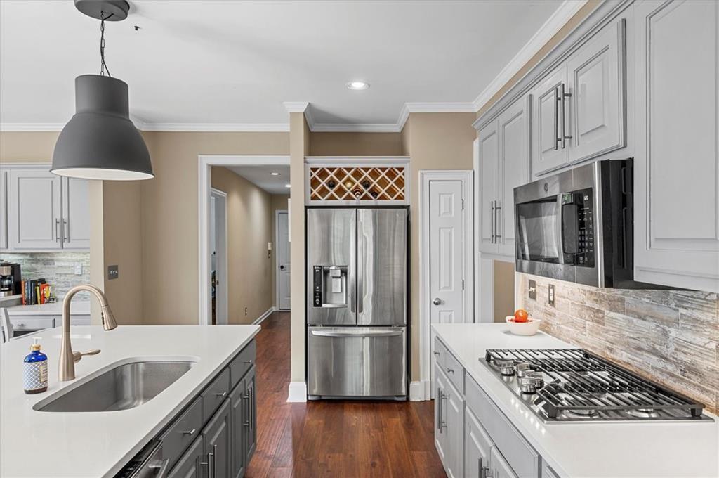 130 Belvedere Court Atlanta, GA 30350 - Photo 19 of 59 a kitchen with stainless steel appliances granite countertop a sink stove and refrigerator
