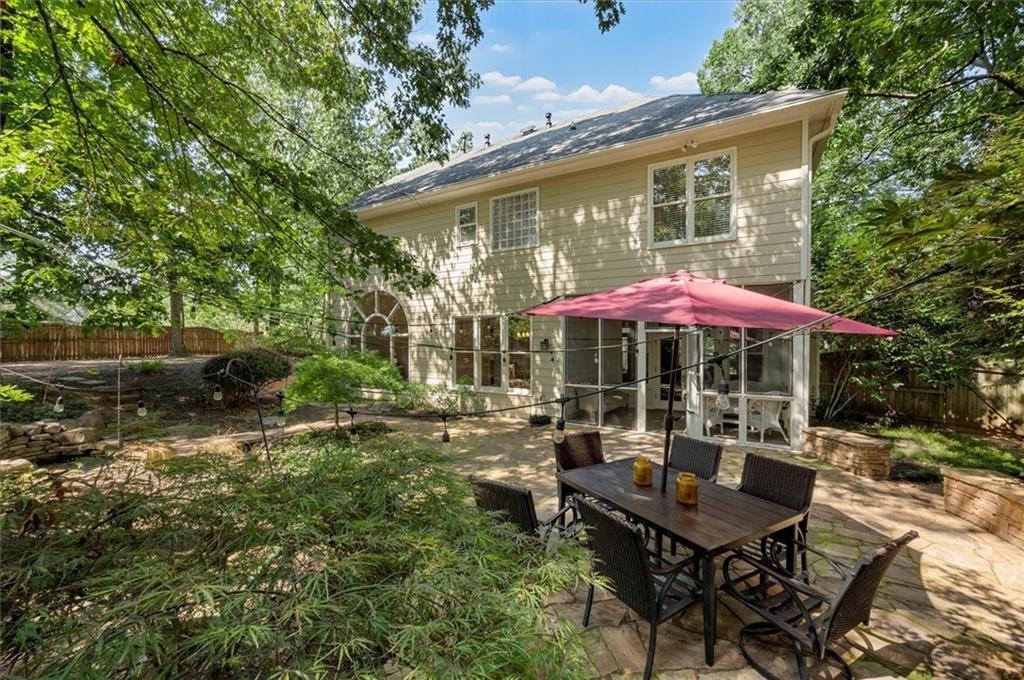 130 Belvedere Court Atlanta, GA 30350 - Photo 2 of 59 a backyard of a house with table and chairs under an umbrella