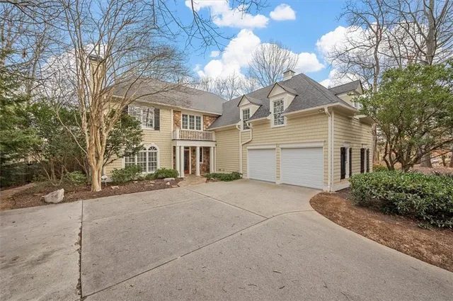 a view of a house with a yard and garage
