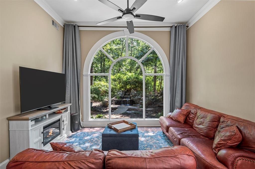 130 Belvedere Court Atlanta, GA 30350 - Photo 4 of 59 a living room with furniture a flat screen tv and a large window