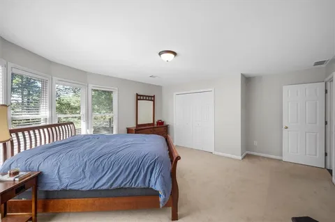 a bedroom with a bed and a dresser in it