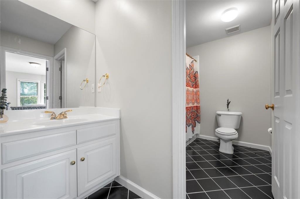 130 Belvedere Court Atlanta, GA 30350 - Photo 46 of 59 a bathroom with a toilet sink and mirror