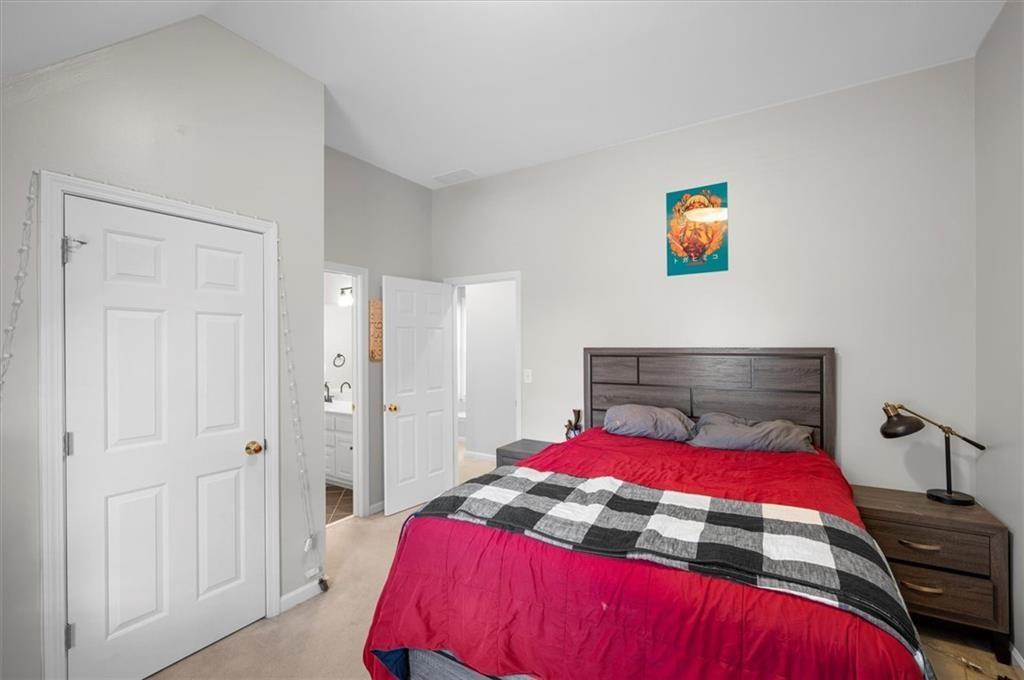 130 Belvedere Court Atlanta, GA 30350 - Photo 48 of 59 a bedroom with a bed and a potted plant