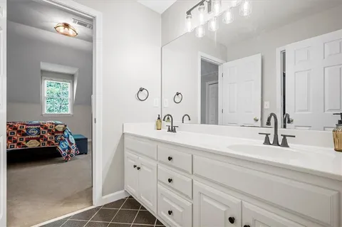 a backyard of a house with table and chairs under an umbrella