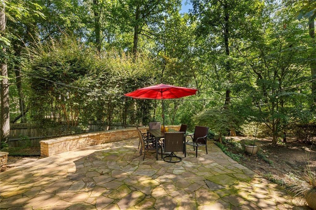 130 Belvedere Court Atlanta, GA 30350 - Photo 57 of 59 a backyard of a house with table and chairs under an umbrella