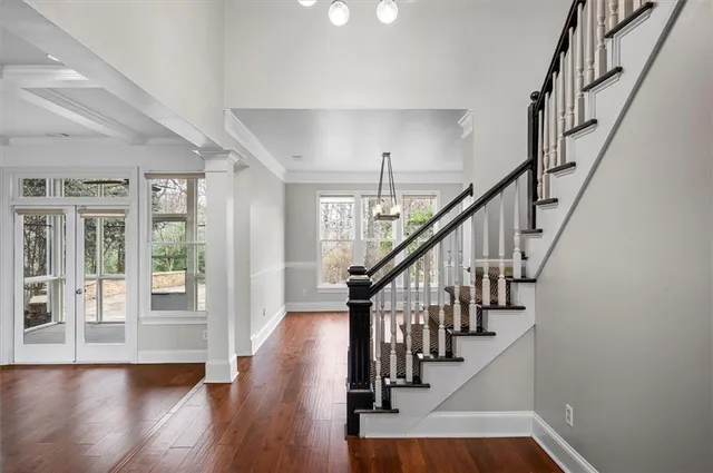 a view of an entryway with wooden floor and stairs
