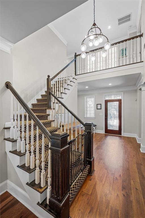 130 Belvedere Court Atlanta, GA 30350 - Photo 9 of 59 a view of staircase with wooden floor and a chandelier