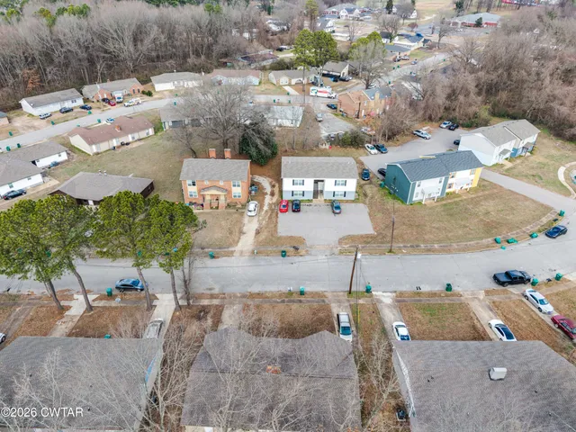 an aerial view of residential houses with outdoor space
