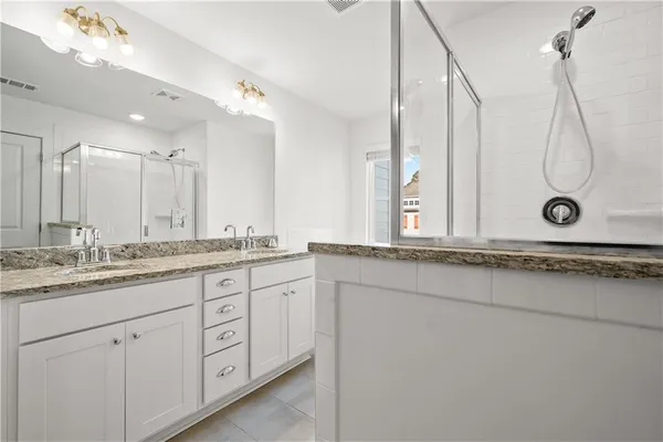 a bathroom with a granite countertop sink mirror and a