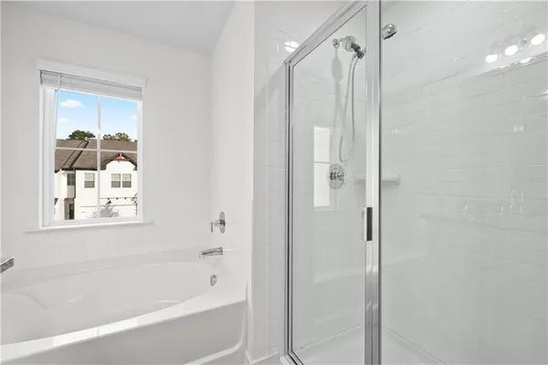 a bathroom with a granite countertop double vanity sink and a mirror