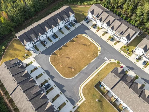 an aerial view of a swimming pool with outdoor seating