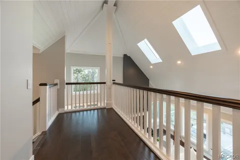 a view of hallway with wooden floor