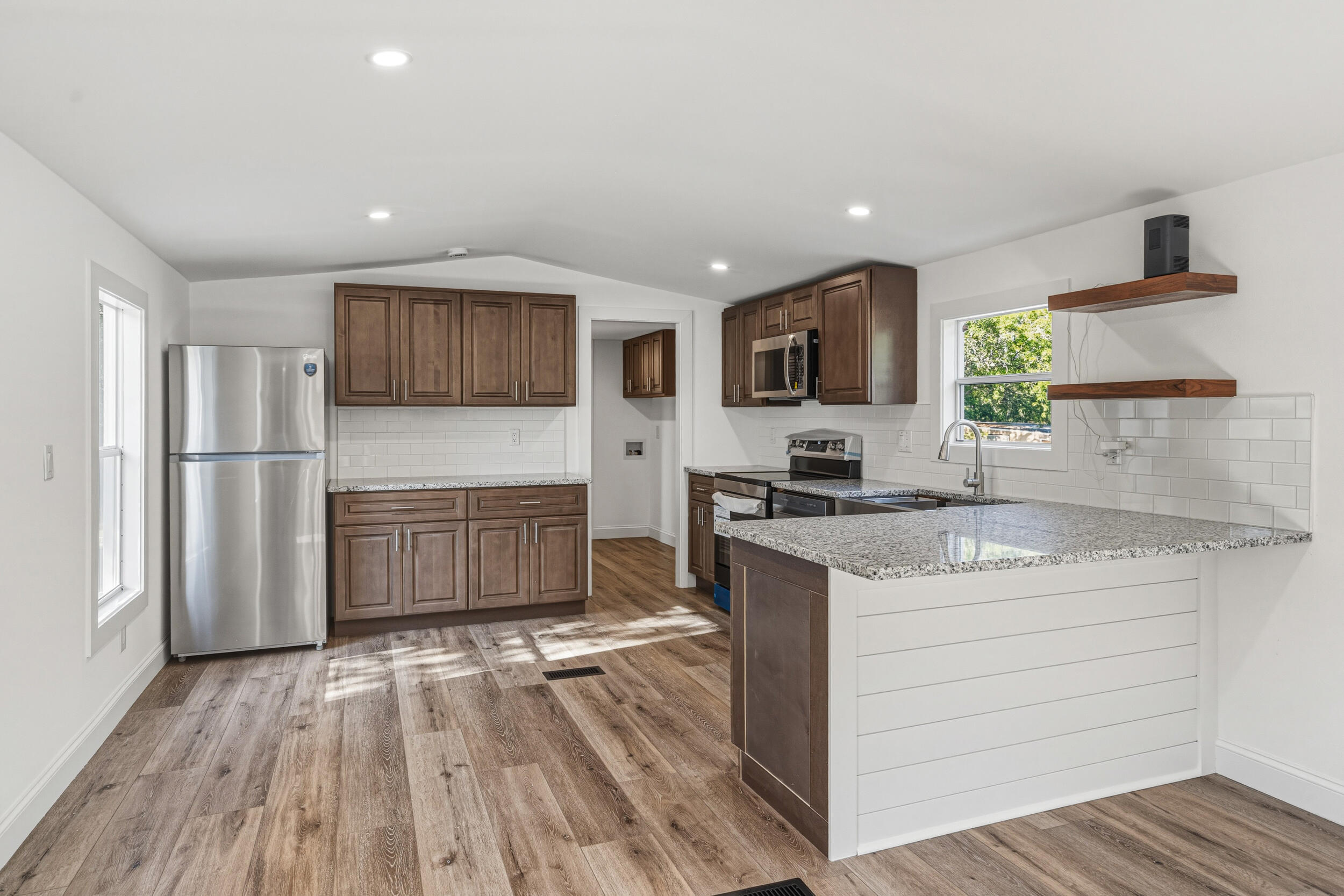 4249 Barlow Road Crestview, FL 32536 - Photo 11 of 40 a kitchen with a refrigerator and a stove top oven