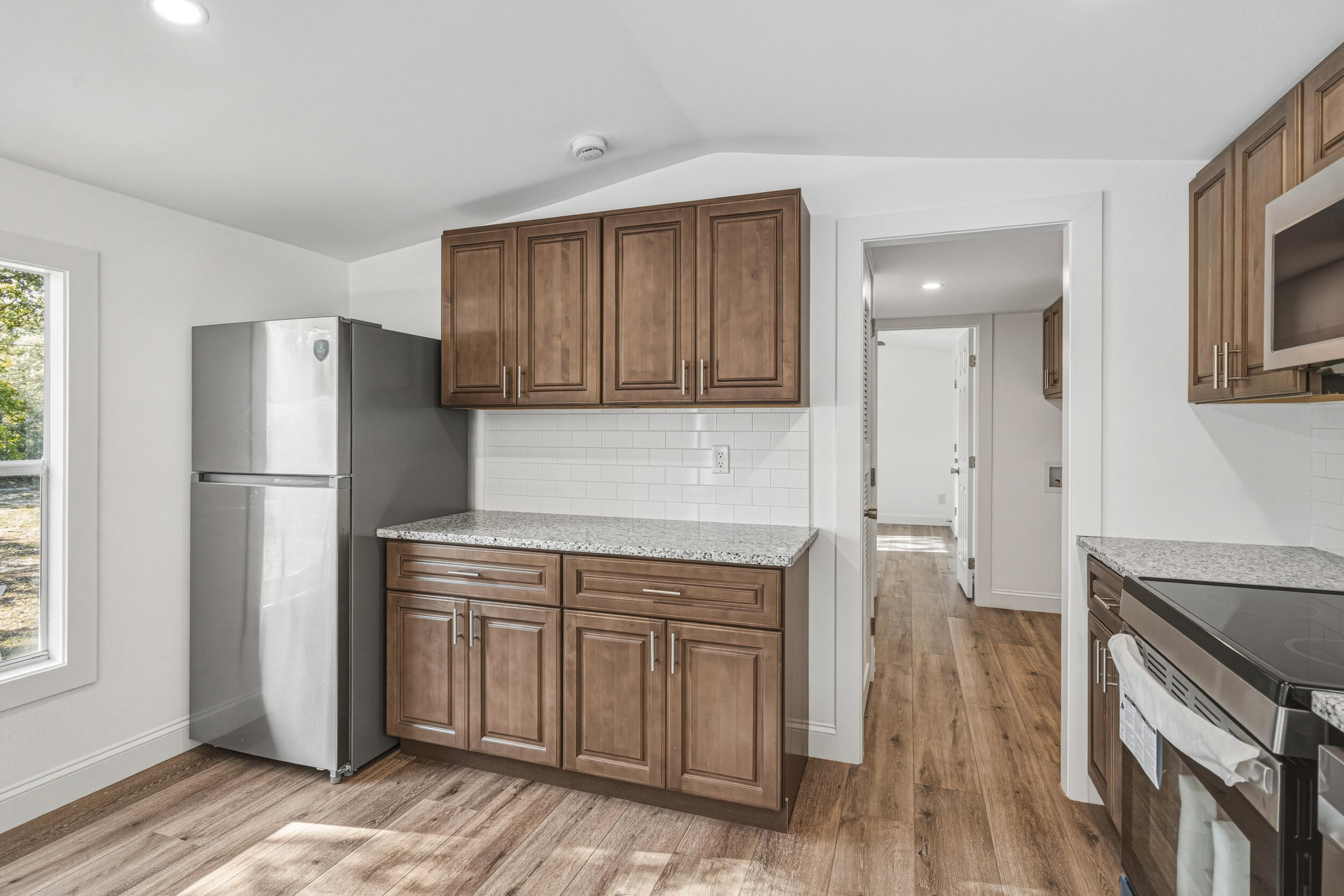 4249 Barlow Road Crestview, FL 32536 - Photo 14 of 40 a kitchen with a refrigerator sink and cabinets