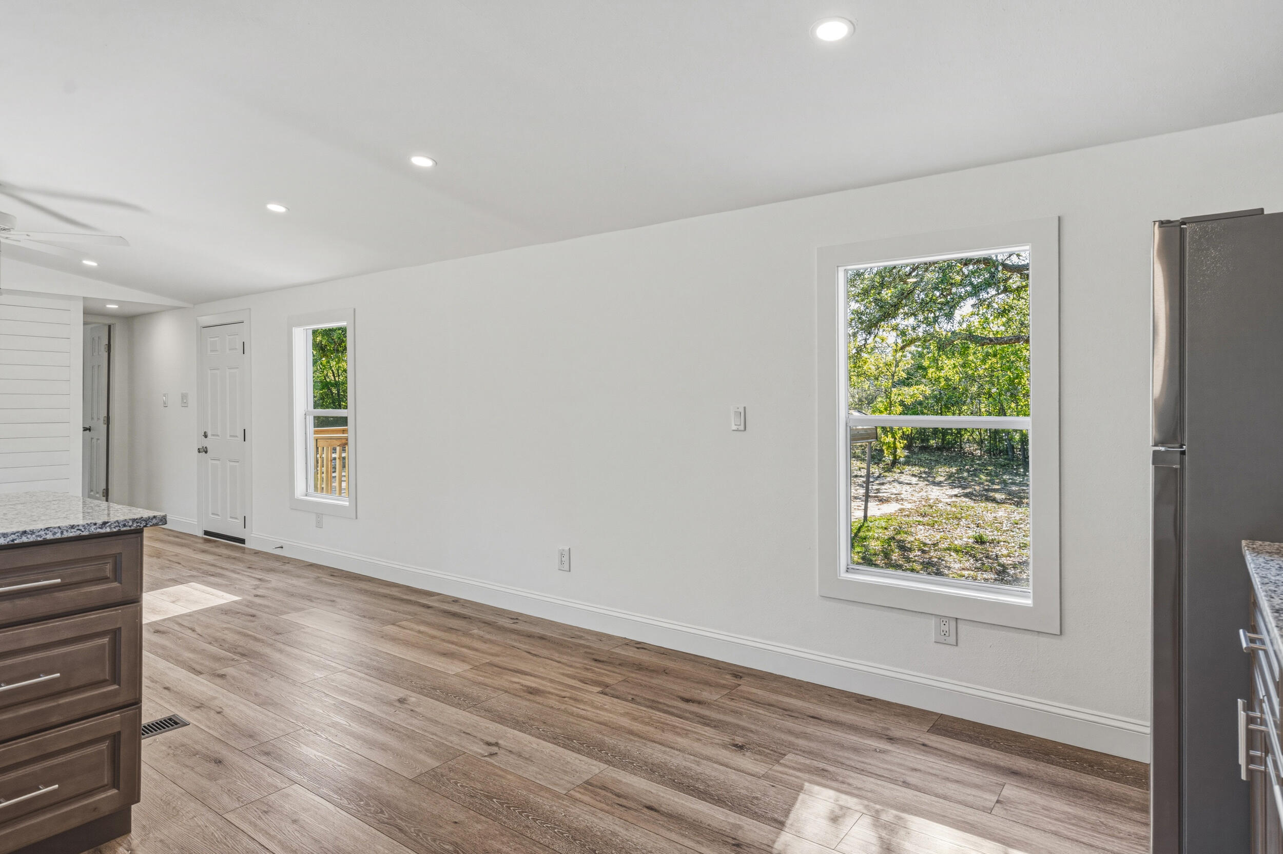 4249 Barlow Road Crestview, FL 32536 - Photo 15 of 40 a view of an empty room with wooden floor and a window