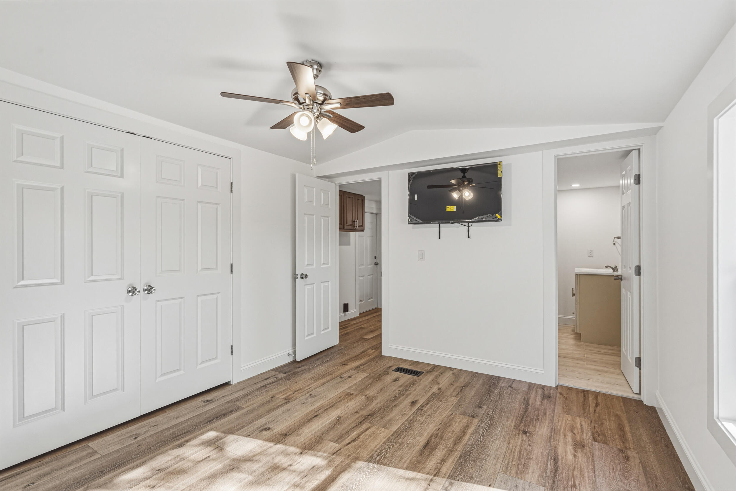 4249 Barlow Road Crestview, FL 32536 - Photo 21 of 40 a view of a livingroom with wooden floor and a ceiling fan