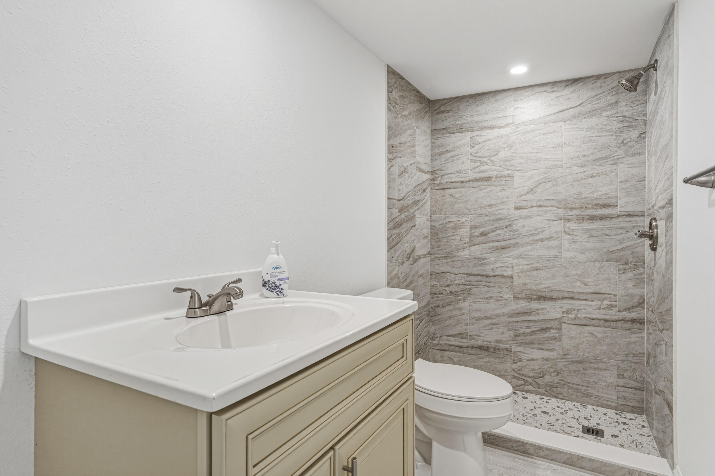 4249 Barlow Road Crestview, FL 32536 - Photo 27 of 40 a bathroom with a sink a toilet and shower