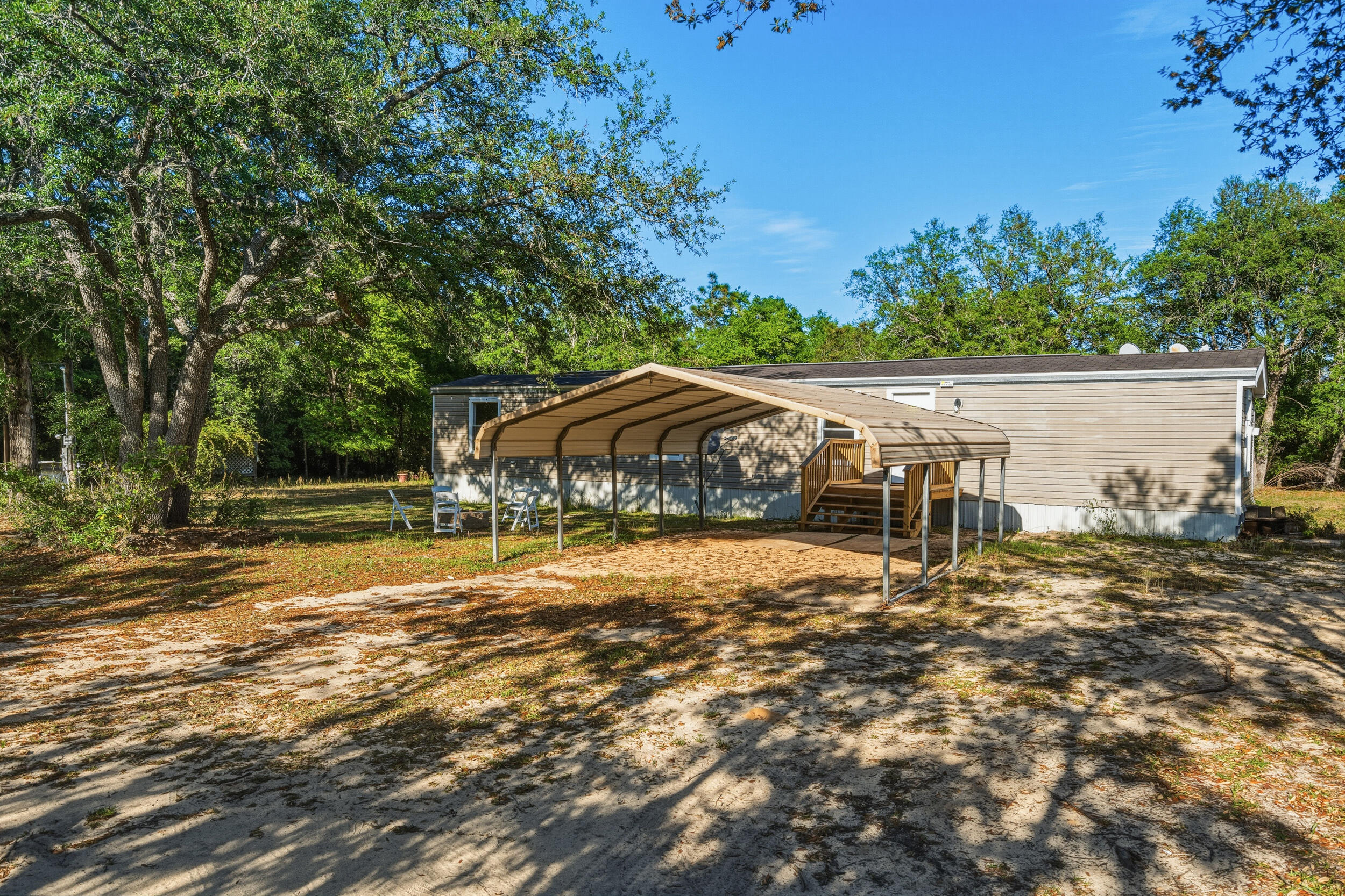 4249 Barlow Road Crestview, FL 32536 - Photo 3 of 40 a view of a house with yard and sitting area