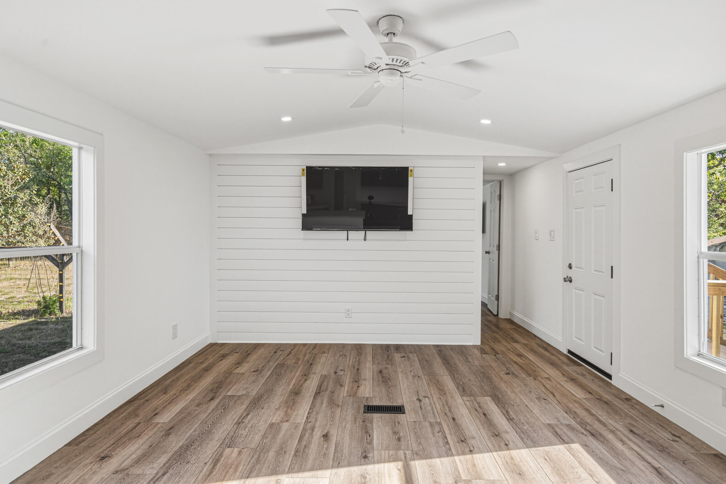 4249 Barlow Road Crestview, FL 32536 - Photo 9 of 40 a view of a livingroom with wooden floor and a ceiling fan