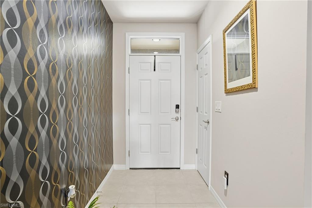 4121 68th Avenue Northeast Naples, FL 34120 - Photo 11 of 33 a view of a hallway with wooden floor