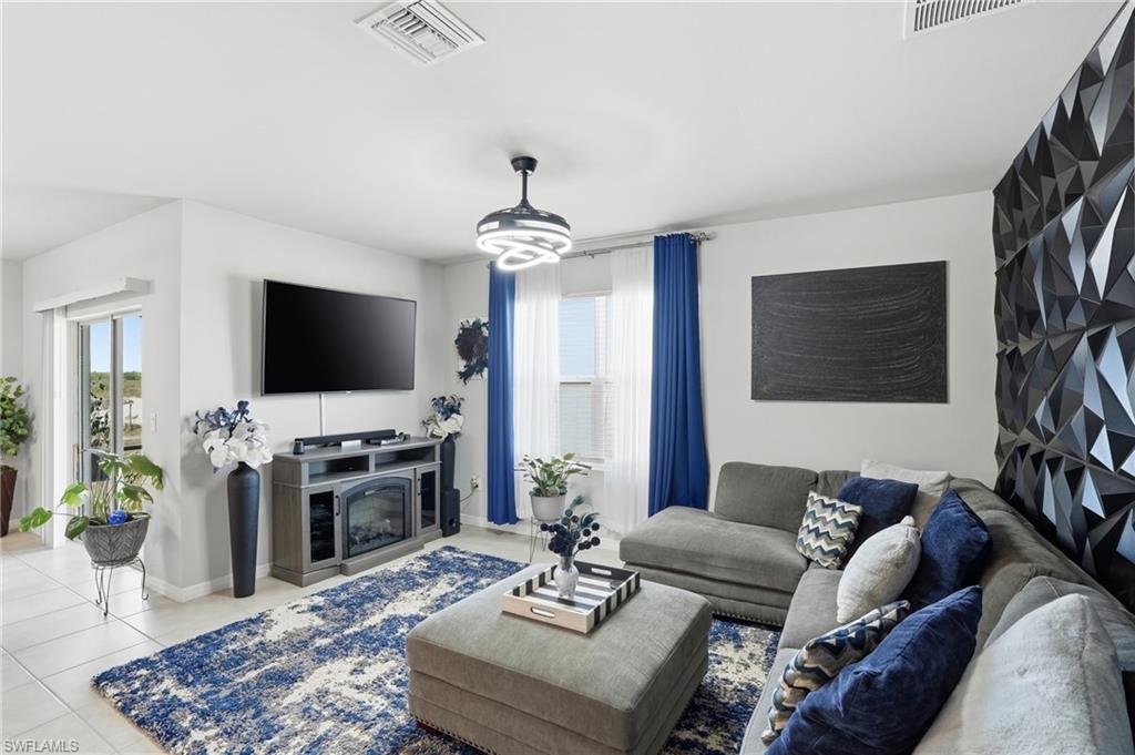 4121 68th Avenue Northeast Naples, FL 34120 - Photo 13 of 33 a living room with furniture and a flat screen tv