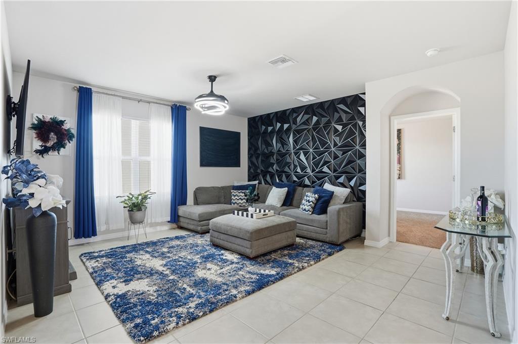 4121 68th Avenue Northeast Naples, FL 34120 - Photo 14 of 33 a living room with furniture and a rug