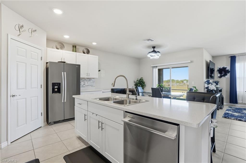 4121 68th Avenue Northeast Naples, FL 34120 - Photo 15 of 33 a kitchen with stainless steel appliances a sink a stove and refrigerator