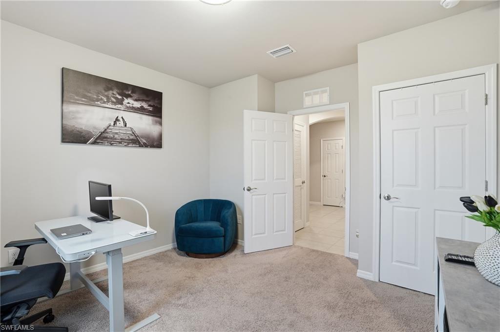 4121 68th Avenue Northeast Naples, FL 34120 - Photo 16 of 33 a workspace with a table and chairs
