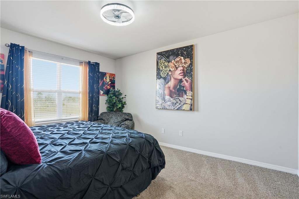4121 68th Avenue Northeast Naples, FL 34120 - Photo 18 of 33 a bedroom with a bed and a painting on the wall