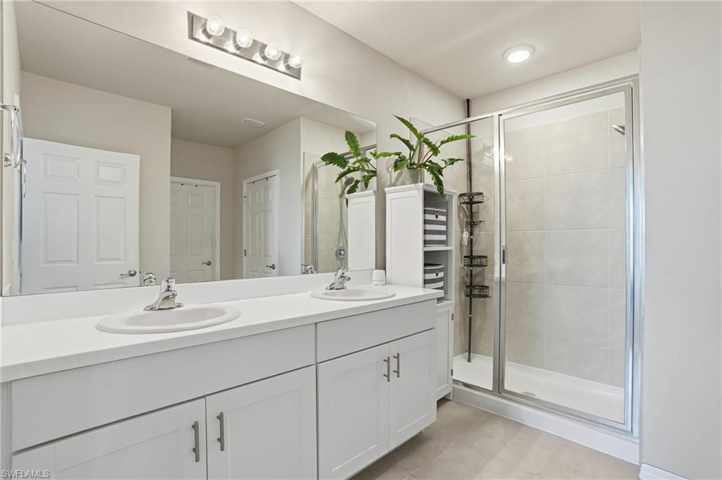 4121 68th Avenue Northeast Naples, FL 34120 - Photo 19 of 33 a bathroom with a double vanity sink mirror and shower
