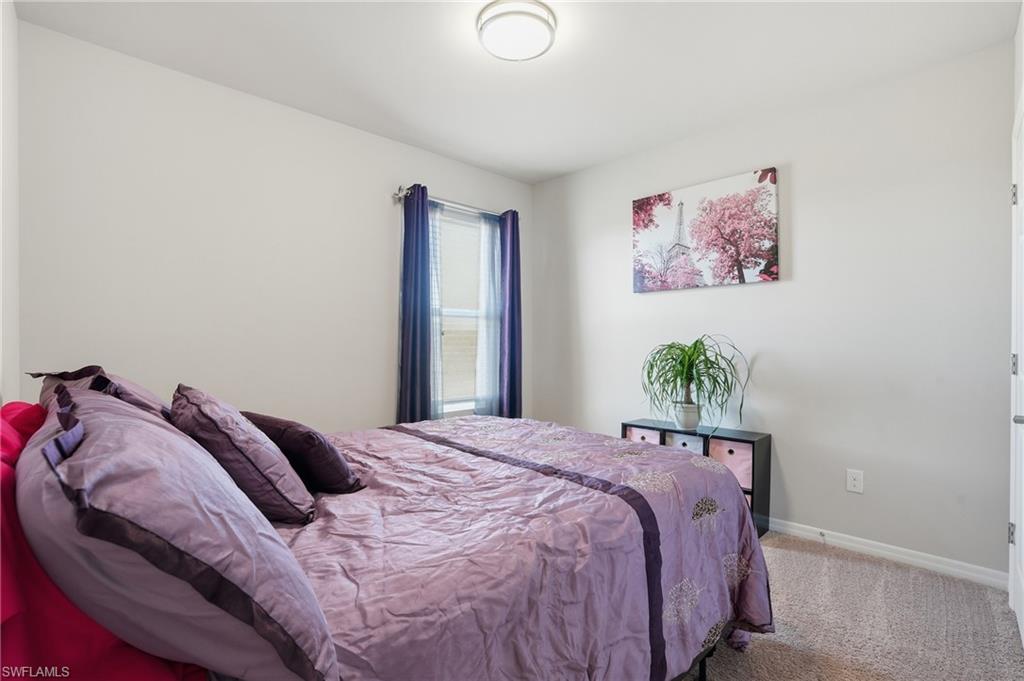 4121 68th Avenue Northeast Naples, FL 34120 - Photo 21 of 33 a bed sitting in a bedroom next to a small bathroom