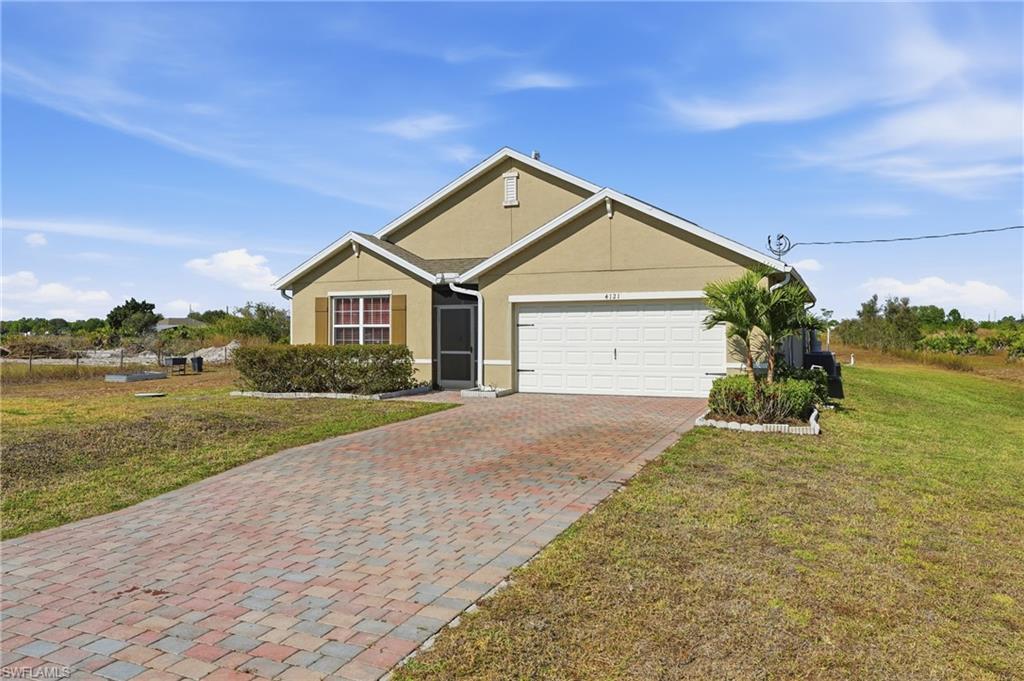 4121 68th Avenue Northeast Naples, FL 34120 - Photo 29 of 33 a front view of a house with a yard and garage